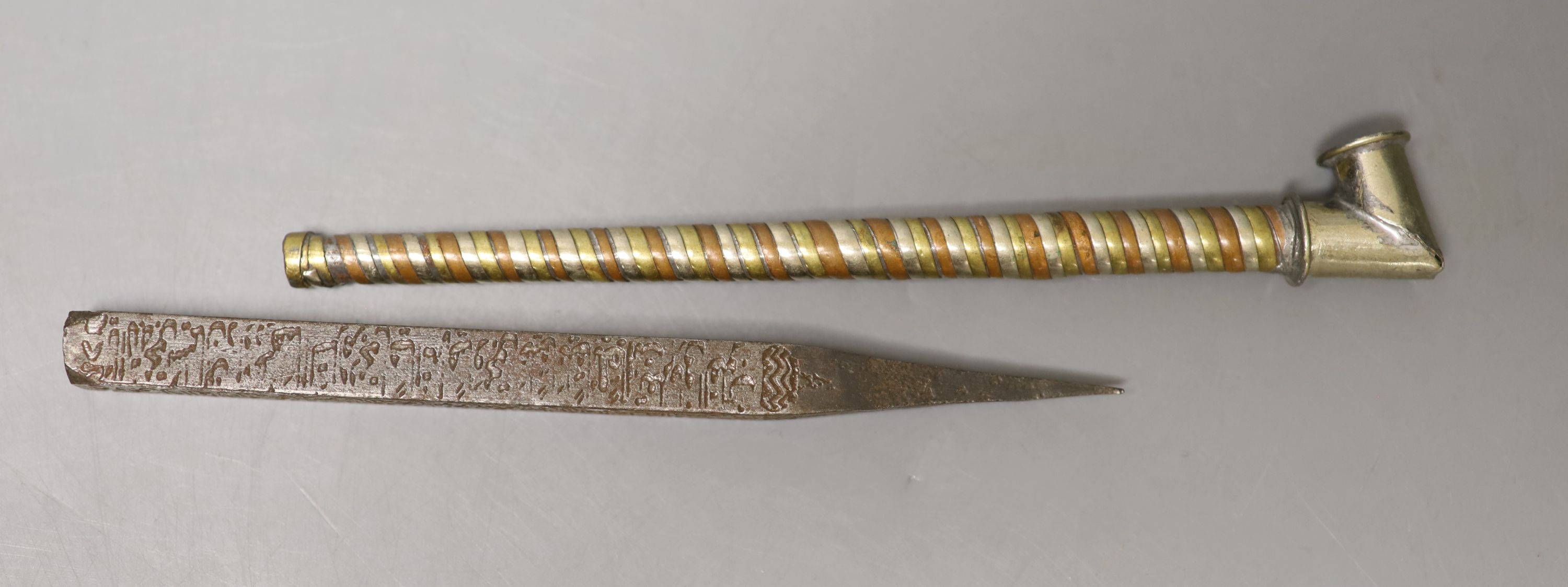 An Islamic architectural nail (driven into the rafters of house during its initial blessing) and a white metal tobacco pipe, decorated with bands